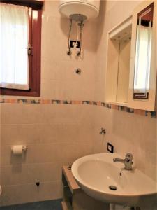 a bathroom with a sink and a mirror at Azzurro in Bibione