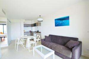 a living room with a couch and a table at La Perle d'Eze - Aparthotel in Éze