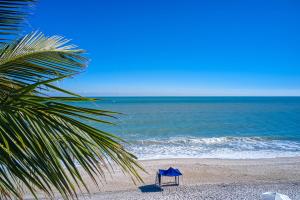 a person sitting on a beach near the ocean at Kimpton Vero Beach Hotel & Spa, an IHG Hotel in Vero Beach