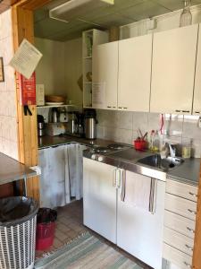 a kitchen with white cabinets and a sink at KTU Kuntomaja in Kokkola +9 photos