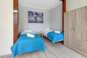 Posteľ alebo postele v izbe v ubytovaní Sopot Baltic Sands Apartment by Grand Apartments