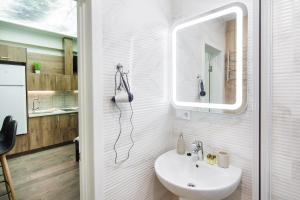 a bathroom with a sink and a mirror at Garden Love on Deribasovskaya in Odesa