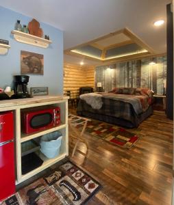 a bedroom with a bed and a kitchen in it at Moosewood Inn in Saint Ignace