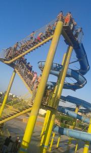 eine Achterbahn in einem Themenpark mit Menschen darauf in der Unterkunft chalet1 ch21 with a wonderful view 2 bed rooms terrace and garden green beach in El-Alamein