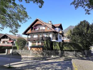 a large house with a fence in front of it at Haus Erika 1911 - Alpspitze in Garmisch-Partenkirchen