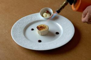 a white plate with a cupcake on a table at Villa Myosotis in Bardonecchia