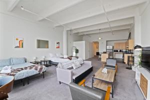 a living room with two beds and a couch at Loft640 in Center City w Parking, Pool, Gym in Philadelphia