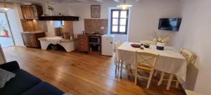 a living room with a table and a kitchen at Salvia in Pićan