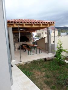 a patio with a table and a pizza oven at Apartment Cres 4496-1 in Cres