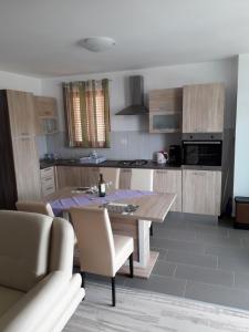 a kitchen with a table and chairs in a room at Apartment Cres 4496-1 in Cres