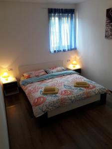 a bedroom with a bed with two lamps on it at Apartment Cres 4496-1 in Cres