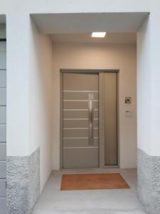 an empty hallway with a door in a building at sweet homes in Lecco +5 photos