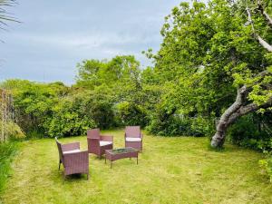 a group of chairs and a table in a field at No 6 Chestnut Grove in Withernsea