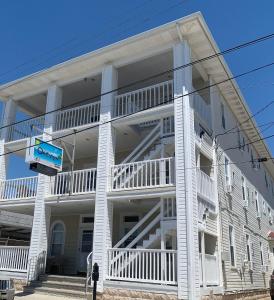 a white apartment building with a large balcony at Oakview Hotel in Wildwood