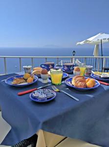 a table with plates of food on a cruise ship at B&B La Danza del Mare in Anacapri