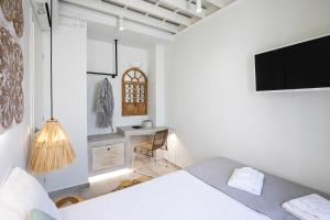 A bed or beds in a room at Thalassa Luxury Studios Lindos