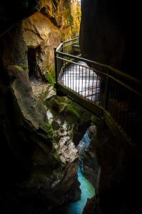 a stairway in a cave with a bridge over a river at Appartamento Il Sogno in Bellano