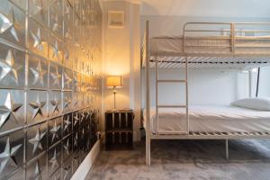 a bedroom with bunk beds and a wall with mirrors at You're Epic in Wimborne Minster