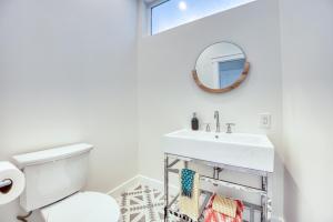 a white bathroom with a sink and a mirror at 727 Sonrisa St home in Solana Beach