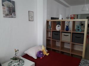 a childs room with a book shelf and stuffed animals at Sadinahome in Setúbal