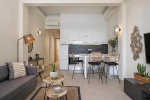 a living room with a couch and a kitchen at Kolymbari Sea Front Cozy Apartments in Kolymvari