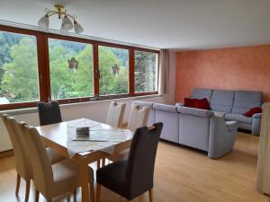 a living room with a table and a couch at Ferienwohnungen Herrmann in Bad Schandau