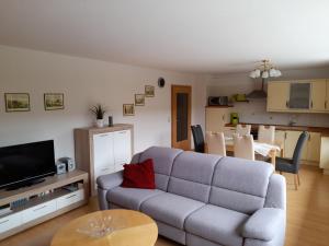 a living room with a couch and a table at Ferienwohnungen Herrmann in Bad Schandau