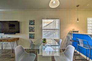 a dining room with a glass table and chairs at Modern Island Condo with Pool Steps to the Beach! in South Padre Island