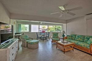 a living room with a couch and a table at Beachfront St Croix Condo with Pool and Lanai! in Christiansted