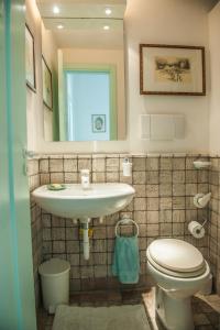 a bathroom with a sink and a toilet at Acquamarina guest house in Marettimo