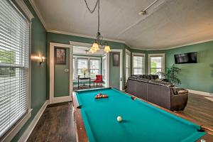 a living room with a pool table in it at Historic Noblesville Home with Private Yard! in Noblesville