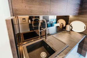 a kitchen with a sink and a refrigerator at Bascarsija's Sights in Sarajevo +56 photos