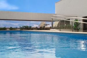 a swimming pool in front of a building at Bristol Imperatriz Maranhao in Imperatriz