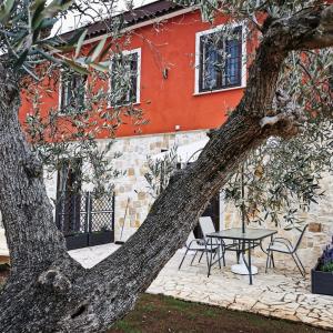 einem Baum mit einem Tisch vor einem Gebäude in der Unterkunft Il Sentiero di Leano in Terracina