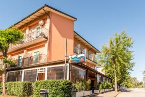 a building with a sign in front of it at Albergo Rosa & Cosetta in Casal Borsetti +36 photos