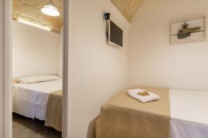 Postel nebo postele na pokoji v ubytování CIVETTHOUSE : la casa delle civette + 28 fotografií