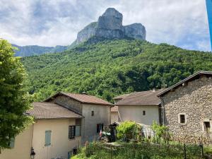 a mountain in the distance with houses in front of it at Le Jorjane Choranche Vercors in Choranche