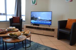 TV a/nebo společenská místnost v ubytování L’Abri