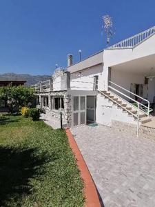 a large white house with a yard and a house at Villa Giulia in Alcamo Marina