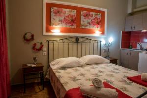 a bedroom with a bed with a flower picture above it at Villa Rafailia in Olympiaki Akti