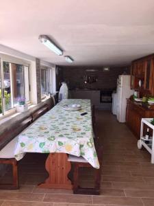 a kitchen with a table with a floral table cloth on it at Villa Giulia in Alcamo Marina