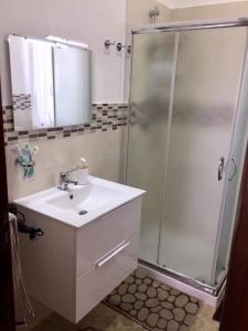 a bathroom with a sink and a shower at Villa Giulia in Alcamo Marina
