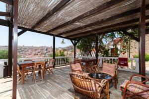 a patio with tables and chairs and a view at Kiki&Nina in Halki