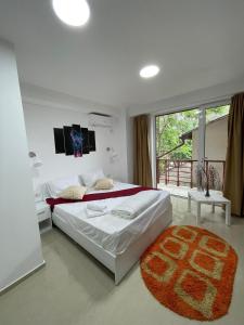a bedroom with a large bed and a large window at Hostel Tripoli Palace in Bucharest +91 photos