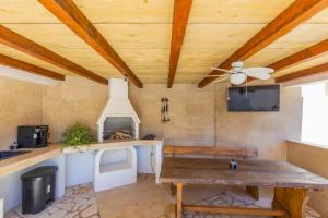 a kitchen with a wooden ceiling and a table at Villa Oasa in Malinska