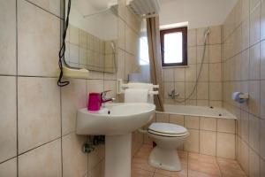 een badkamer met een wastafel, een toilet en een bad bij Apartments Jagoda in Vrbnik +50 foto's