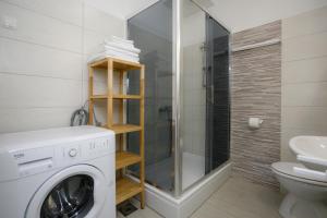 a bathroom with a washing machine and a shower at Oliva in Vrbnik +18 photos