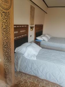 Voodi või voodid majutusasutuse Ciao Hotel toas