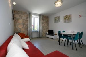 a living room with a couch and a table at Oliva in Vrbnik