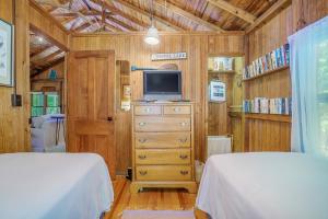 - une chambre avec 2 lits, une télévision et une commode dans l'établissement Park Vogel Cottage, à Frankfort